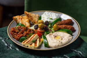 the Best Mediterranean Food in London, A colorful platter of assorted hot and cold meze, showcasing a variety of Mediterranean flavors.